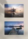 Dwa plakaty fotograficzne przedstawiające wschód słońca nad jeziorem.